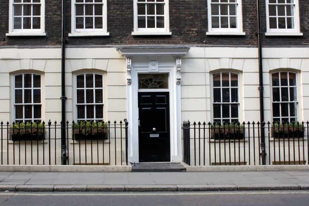 In front of a cream-and-brown-coloured house