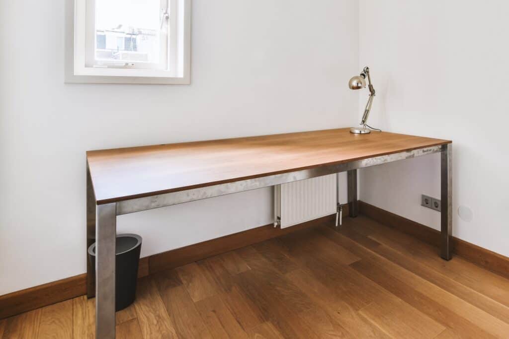 An empty room with a study desk and lamp in the concept of single-item delivery in Wimbledon