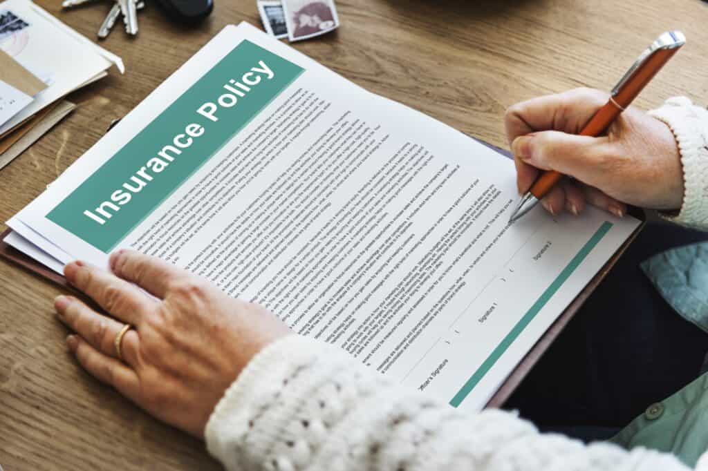 Cropped image of a woman about to sign an insurance policy for the move