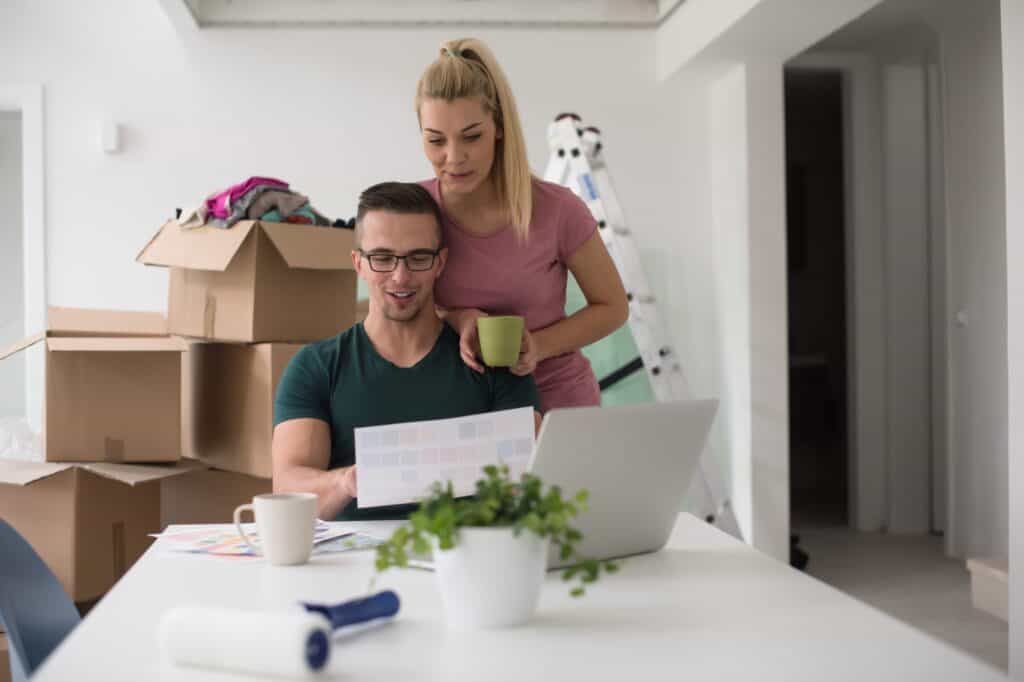 A young couple in their new flat yet to finish the unpacking after moving in